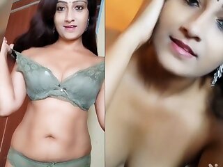 Beautiful Indian housewife striptease in a solo video.